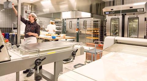 Three chefs in a professional bakery