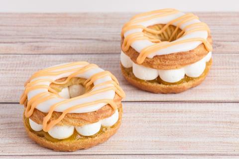 Round choux pastries with cream and apple filling inside and icing on top