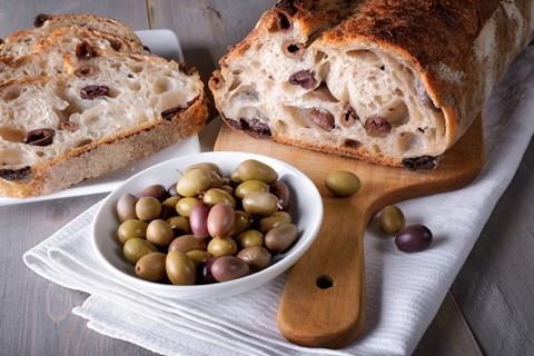 Olive sourdough with a bowl of olives