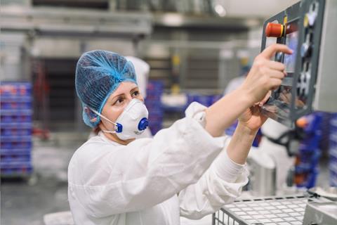 Finsbury Food Group - A worker operates a control panel on a production line - 2100x1400