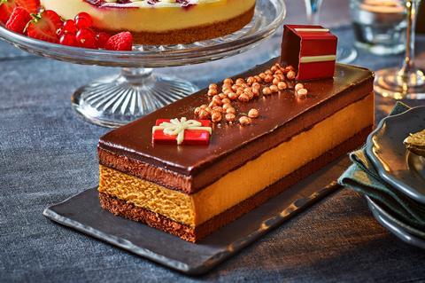 A chocolate dessert with blonde chocolate middle and edible present on top