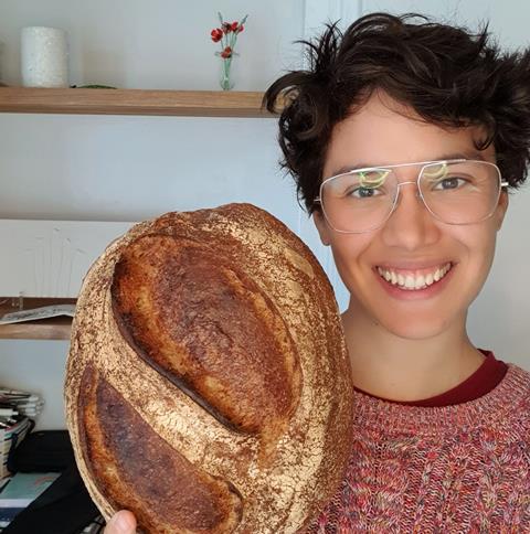 Cindy Zurias holding a sourdough loaf