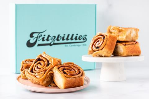 A pile of Chelsea Buns next to a turquoise Fitzbillies box