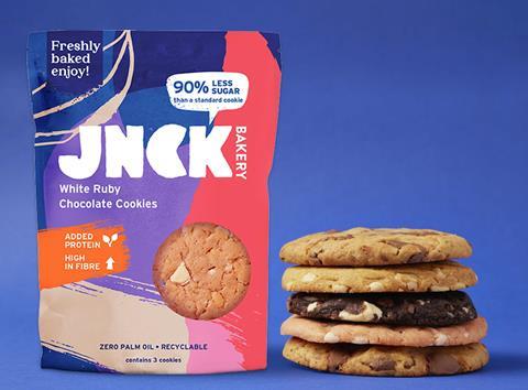 Jnck pack of cookies with a stack of cookies next to it