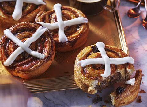 Three Danish pastries decorated to look like hot cross buns