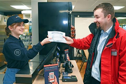 Cardiff Central station manager Nathaniel Owen (right) picks up a pasty at Warren Bakery's new store - credit Richard Swingler  2100x1400