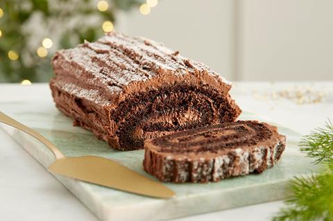 A chocolate yule log with sugar dusting on top