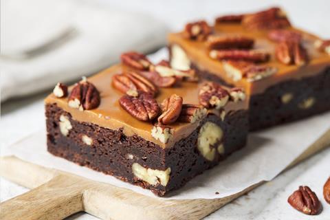 A brownie made with British Bakels Fudgy Brownie Mix topped with caramel and walnuts.