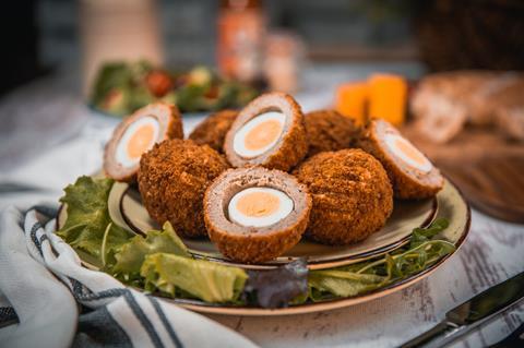 Scotch eggs on a plate with salad