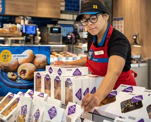 Greggs staff arrange baked goods at the new shop in Cobham 2221x1800