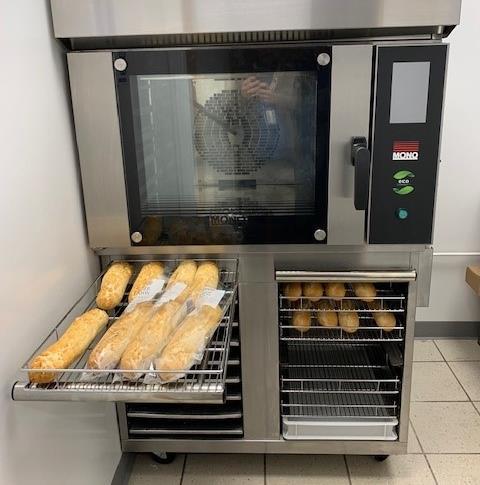 Baguettes on a tray in front of a small Mono oven