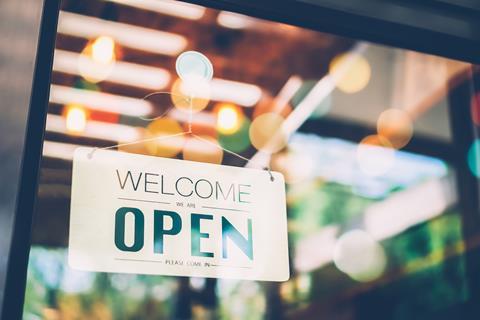 An open sign on a glass door