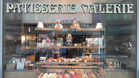 The window of a Patisserie Valerie shop with cakes in it