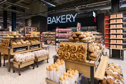 A beautifully stocked M&S in-store bakery with loaves, pretzels, and more