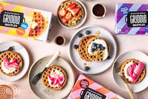 A birds eye view of waffles topped with yoghurt, blueberries and rhubarb