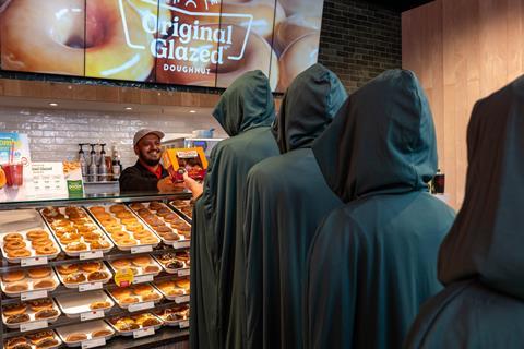 Krispy Kreme - Cloaked consumers queue faithfully to order the new Traitors doughnuts - 2100x1400