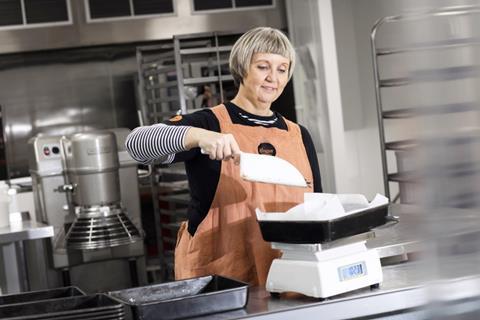 Lisa Smith at Ginger Bakers weighing ingredients