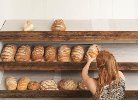 Woman stocking bakery shelves