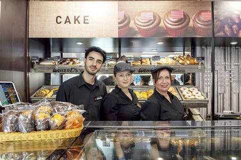 Staff at Wenzel's in front of a cake counter