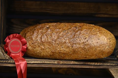 A soft wholegrain loaf next to a winner's rosette