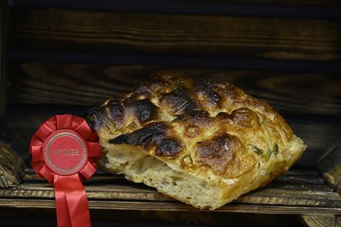 A hearty wedge of rosemary & salt focaccia next to a winner's rosette
