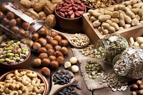 A selection of nuts and seeds on a rustic wooden table