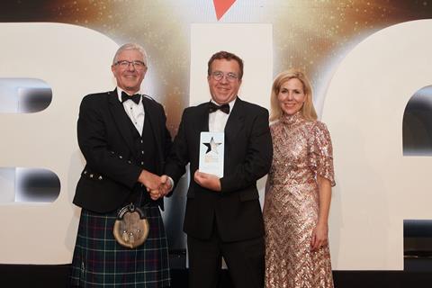A joyful Aidan Monks from Lovingly Artisan (centre) receives the Speciality Bread Product of the Year award from British Bakels ambassador director Keith Houliston and host Sally Phillips