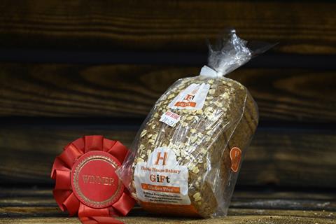 A gluten-free loaf in packaging with a winner's rosette