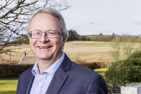 Alastair Macphie with turbines in the background