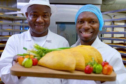 Paul and Mike Williams holding up a tray of patties