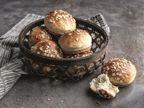 Bread rolls with oats on top in a wicker basket