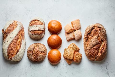 Sourdough loaves, brioche buns and dinner rolls on a great background