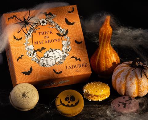 Trick or macarons with pumpkins and fake spiderwebs