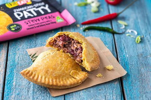 A Jamaican patty cut in half with kidney beans inside