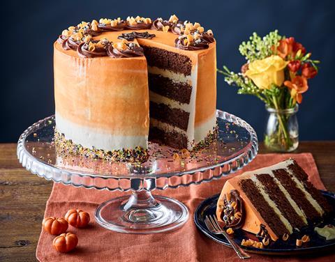 Four layer chocolate cake with orange frosting and dark chocolate swirls