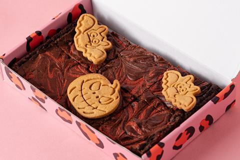 Chocolate brownies with red swirls and gingerbread bats on top
