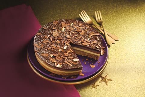 A chocolate and caramel cheesecake on a gold background