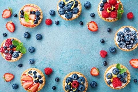 Individual fruit tarts with blueberries and raspberries