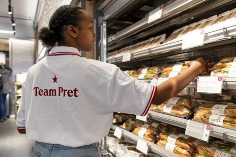 A worker stocks a chiller with sandwiches at a Pret shop in the US  2100x1400