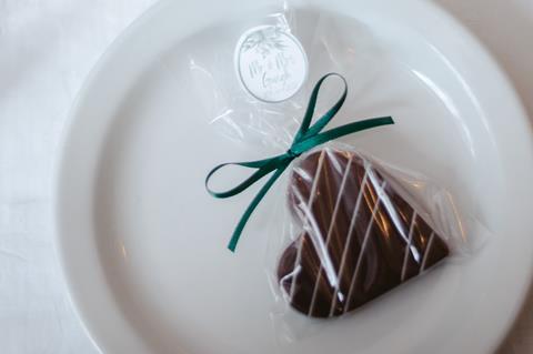 A chocolate topped shortbread heart with bow