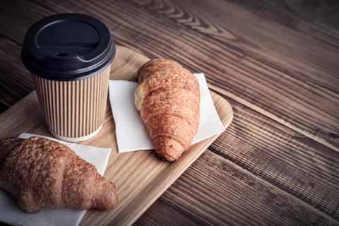 Takeaway coffee cup and two croissants
