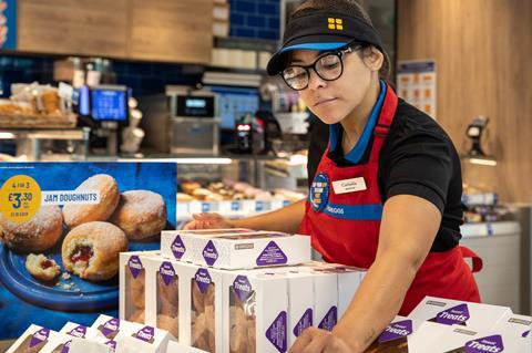 Greggs staff arrange baked goods at the new shop in Cobham