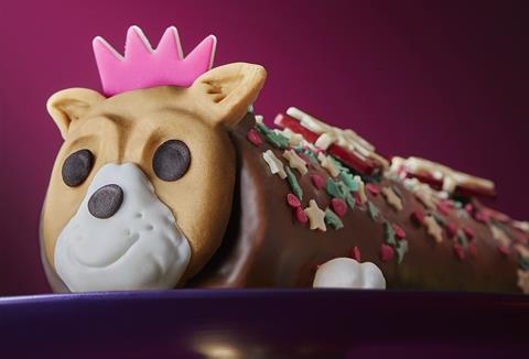 A chocolate roll cake with edible Jack Russell face
