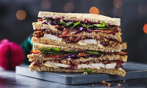 A Christmas Club Sandwich layered with turkey, bacon, slaw, and cranberry sauce