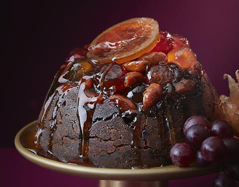 A Sicilian Orange And Whisky Christmas Pudding with glazed cherries and orange slices on top