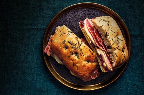 A rosemary focaccia with turkey, bacon and cranberry sauce inside