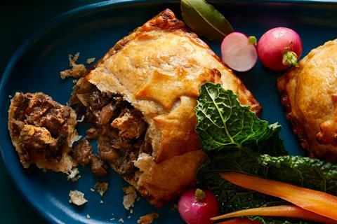 A Festive plant-based wellington with roast radishes and carrots on a blue plate