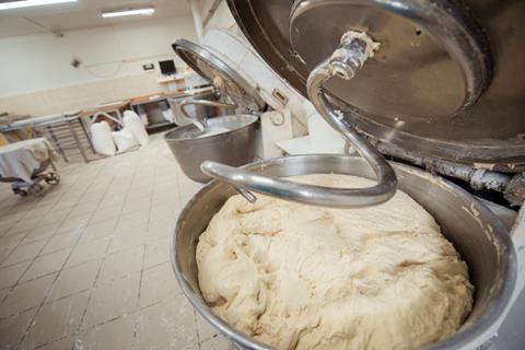 Industrial bakery mixer with dough in it