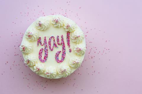 A celebration cake with 'yay' on it in sprinkles
