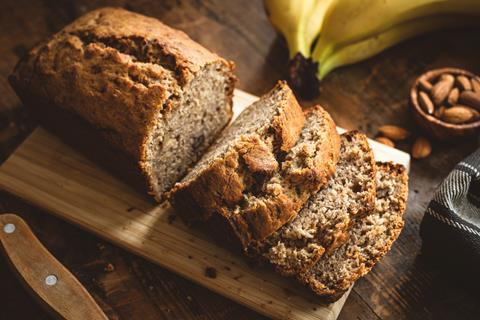 Banana and walnut cake on wooden board